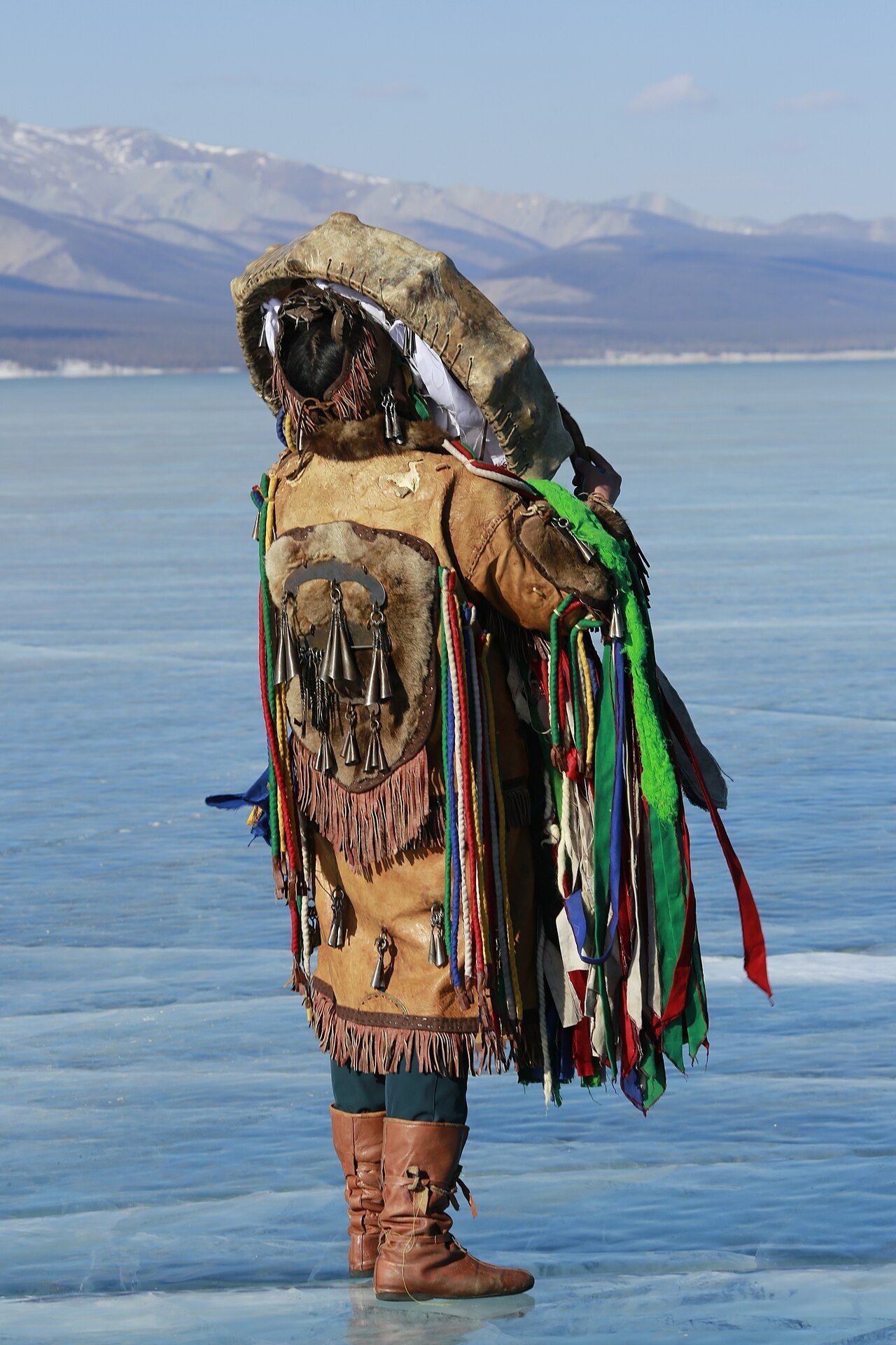 A Darkhad shaman in Mongolia beginning a ritual, holding a frame drum