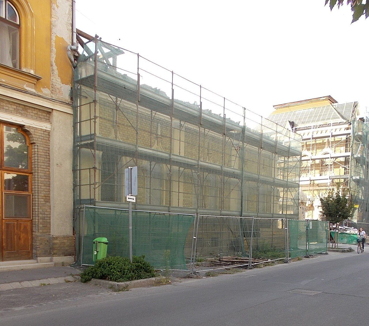 Steel scaffolding erected around a building under construction, showing the ordered framework beneath a facade