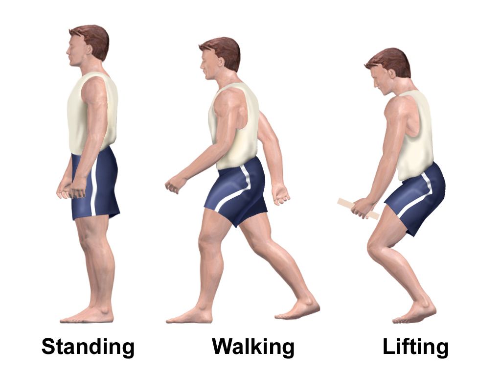 A staff member standing at an angle rather than face on, hands visible and open, maintaining several feet of space from an agitated person near an open doorway