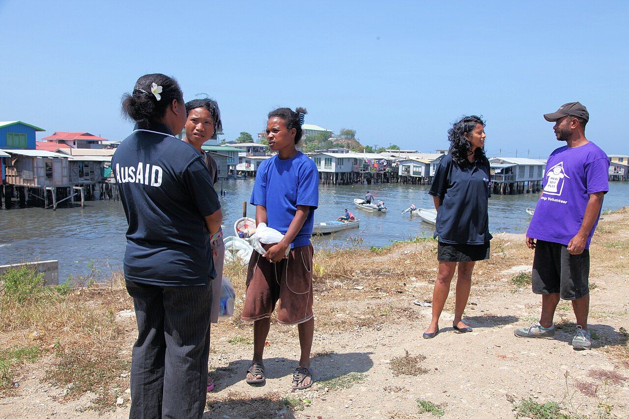 Researchers talking with community members in a village setting