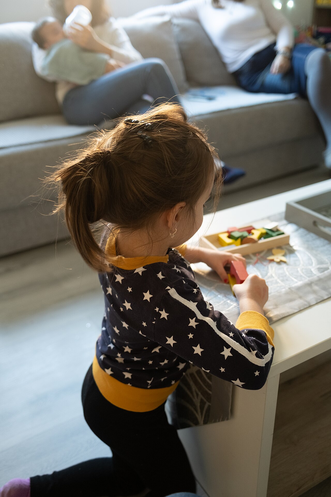 A young child playing with colorful toys