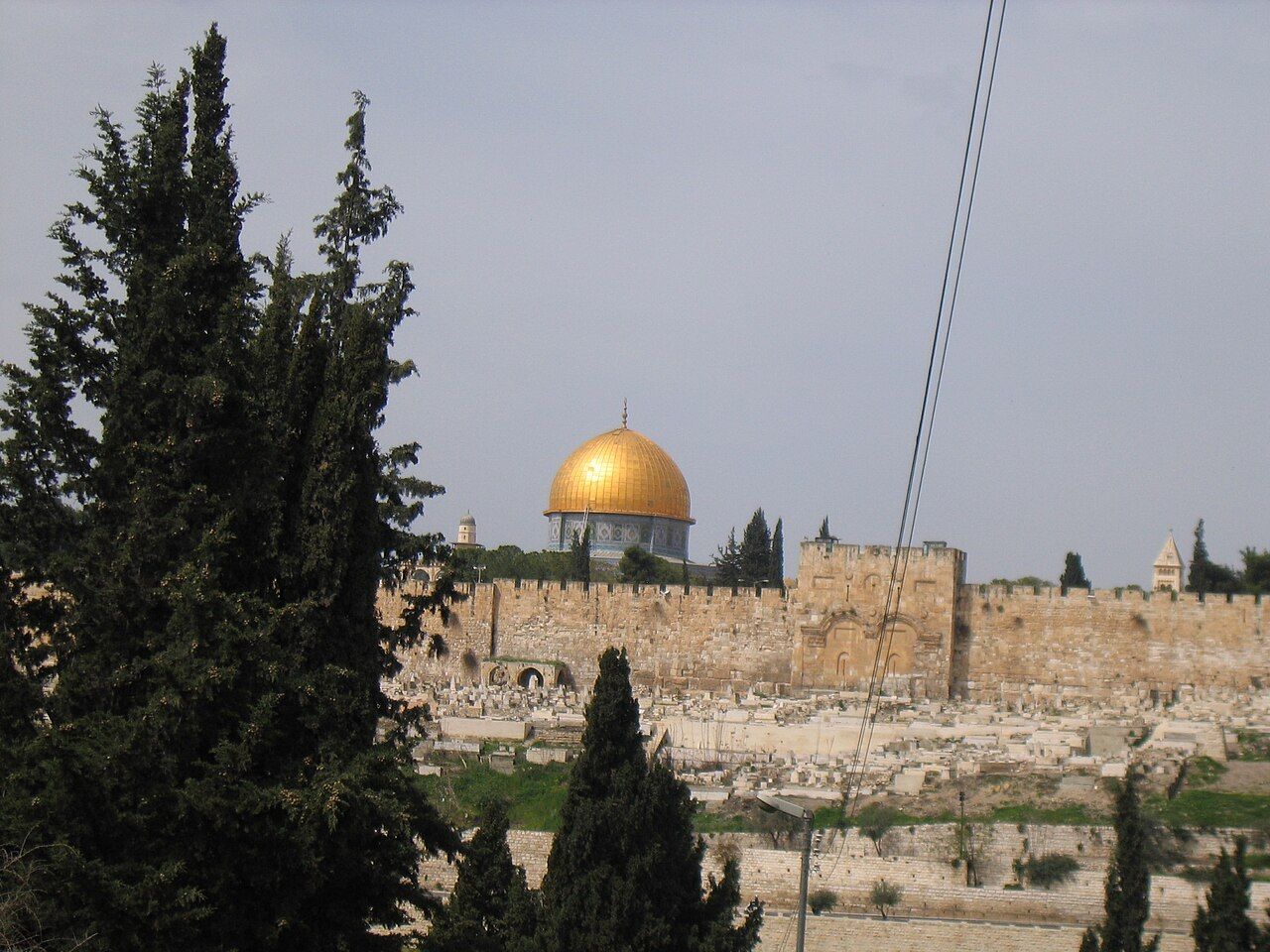 The Dome of the Rock in Jerusalem, an octagonal building with a gilded dome and bands of tile and mosaic decoration
